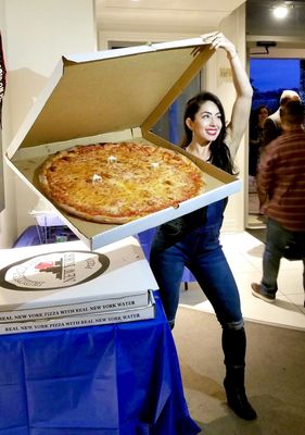 Photo of Eddie & Sam's NY Pizza - Tampa, FL, US. I'm 5'4", normal sized chick next to HUGE pizza! So heavy. Delicious.