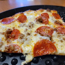 Giuseppe’s Italian Restaurant - White pizza with pepperoni and sausage.