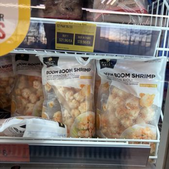 Wild Fork - Frozen Boom Boom Shrimp with Sriracha Aioli in clear packaging, displayed in a freezer at Wild Fork in Buffalo Grove, IL, with a yellow price tag above. - Meat Shops Near Me - Buffalo Grove, Illinois