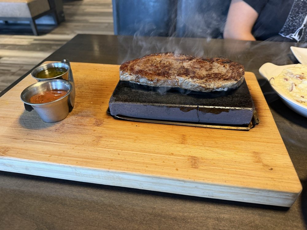 Avi’s steak On A Stone Logo