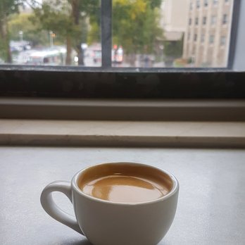 Louis Loft - a cup of coffee in front of a window - Coffee & Tea Near Me - Saskatoon, Saskatchewan Louis Loft - a cup of coffee in front of a window - Coffee & Tea Near Me - Saskatoon, Saskatchewan