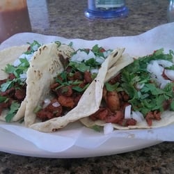 Sunshine Neighborhood Market - Two tacos al pastor on the left and one taco de pollo on the right. On fresh made corn tortillas.