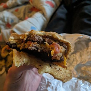 Wayback Burgers - a hand holding a half eaten sandwich - Burgers Near Me - Edmonton, Alberta Wayback Burgers - a hand holding a half eaten sandwich - Burgers Near Me - Edmonton, Alberta