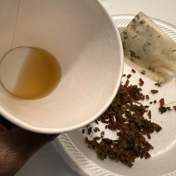 Fuji at Founders Square - To-go cup, teabag, contents of the teabag on a styrofoam plate. - Sushi Bars Near Me - Naples, Florida Fuji at Founders Square - To-go cup, teabag, contents of the teabag on a styrofoam plate. - Sushi Bars Near Me - Naples, Florida