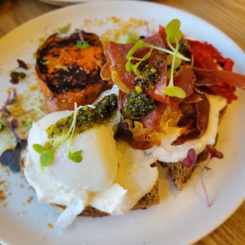 MIAM - Iberian Toast: sourdough bread with Iberian ham, ricotta, roasted peppers, poached egg, pistachio pesto, dukkah, and baked sweet potato. - Coffee & Tea Near Me - Barcelona, B