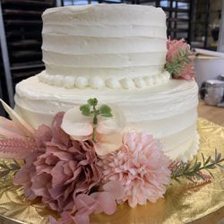Century Bakery - Two tiers of our classic cake, iced, and decorated with our famous buttercream