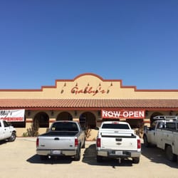 The front of Gabby's - paved parking lot is west of the building