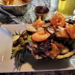 Hacienda Leon Mexican Kitchen + Bar - Pina Loca - Grilled beef, chicken, shrimp, peppers, onions and pineapple all served in a halved pineapple  Delicious