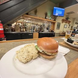 Crab cake sandwich with seasoned rice and cold pint on a hot summer's day Crab cake sandwich with seasoned rice and cold pint on a hot summer's day