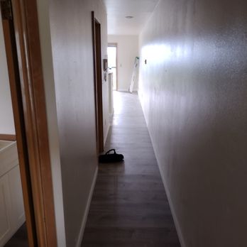 Rodas Construction - a long hallway with wood floors - General Contractors Near Me Rodas Construction - a long hallway with wood floors - General Contractors Near Me
