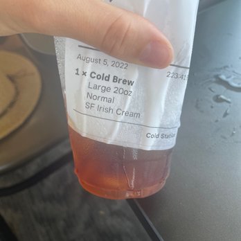 Alley Cats Coffee - a hand holding a cup of cold brew - New American Near Me - Spooner, Wisconsin Alley Cats Coffee - a hand holding a cup of cold brew - New American Near Me - Spooner, Wisconsin