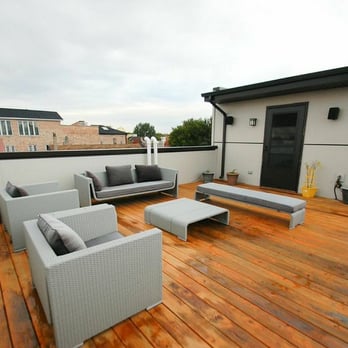 Punch Construction - A rooftop deck featuring artificial grass and cedar decking in West Loop by Punch Construction. - General Contractors Near Me - Chicago, Illinois Punch Construction - A rooftop deck featuring artificial grass and cedar decking in West Loop by Punch Construction. - General Contractors Near Me - Chicago, Illinois