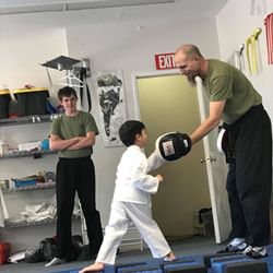Los Padres Kung Fu San Soo - Master Joe with a Little Dragon in our youngest class practicing footwork and punching techniques on the balance blocks.