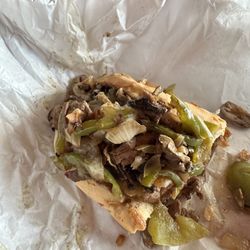 Mega Burgers - What it got vs what I ordered (thin cut Philly cheesesteak with yellow cheese. No onions or raw peppers is what shown on the menu.)