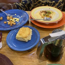 Grits, biscuit, eggs and potatoes