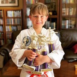 Tom Vo's Taekwondo - Our Gremlin with his Tom Vo Taekwondo Tournament Trophies.