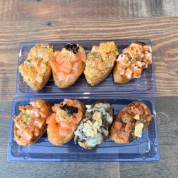 a variety of sushi in plastic containers a variety of sushi in plastic containers
