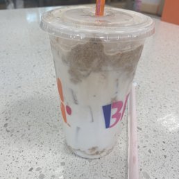  a drink with a straw in a plastic cup