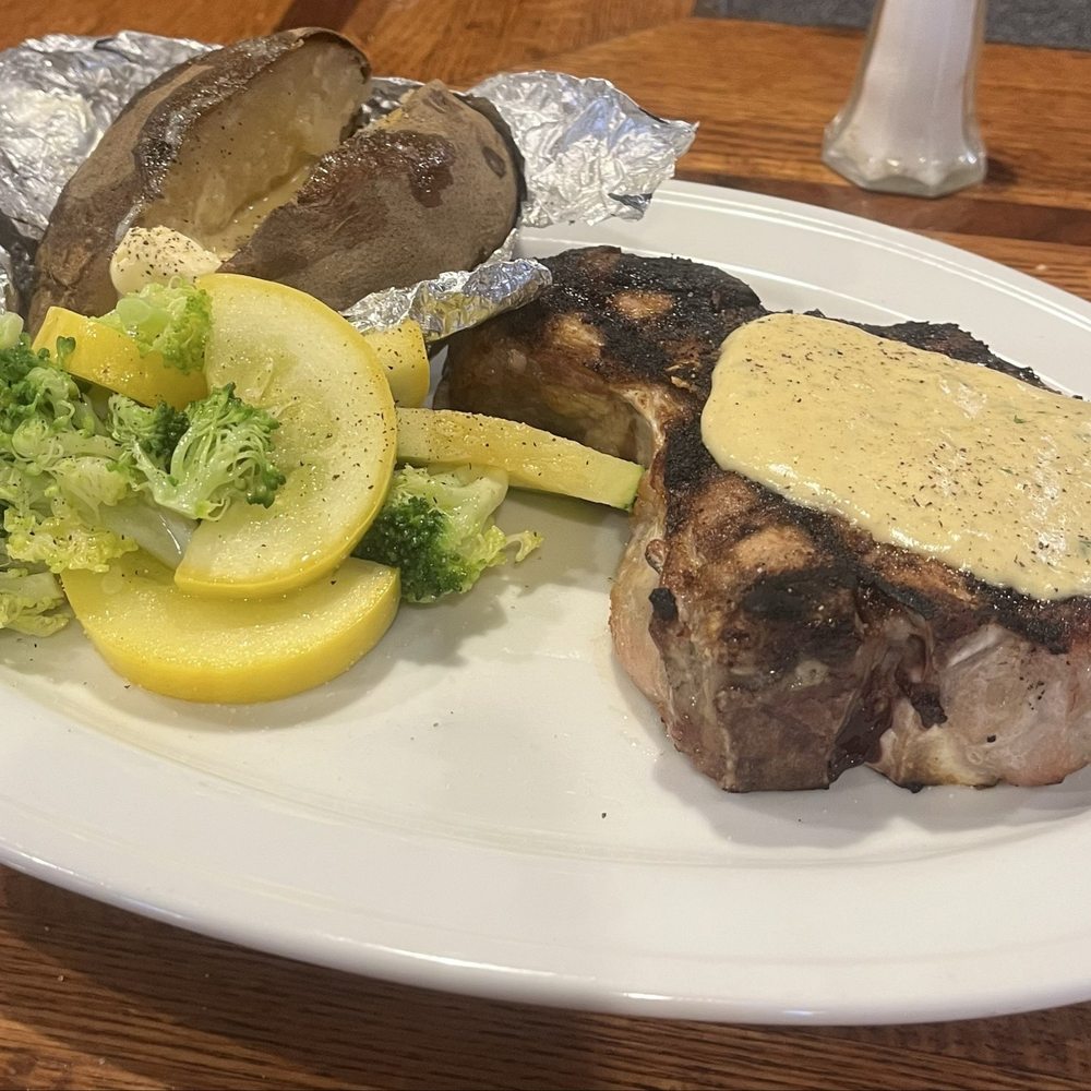 16oz bone in pork chop, baked potato, seasonal mixed vegetables 16oz bone in pork chop, baked potato, seasonal mixed vegetables