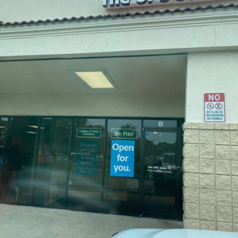 The UPS Store - Social distancing sign but no mask. - The UPS Store in Saint Augustine, FL, features a glass entrance with signs indicating services and hours, and a no skateboarding sign on the side. - Shipping Centers Near Me - Saint Augustine, Florida