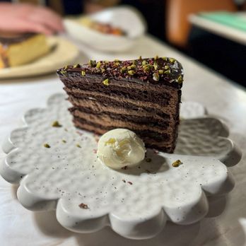 Alora - Chocolate Cake for 2 - Baharat spiced ten-layer cake, pistachio, rose petal, cream cheese ice cream - Mediterranean Near Me - San Francisco, California Alora - Chocolate Cake for 2 - Baharat spiced ten-layer cake, pistachio, rose petal, cream cheese ice cream - Mediterranean Near Me - San Francisco, California