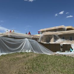Sangre De Cristo Roof Company - They wrapped the whole house to protect against overspray in windy conditions