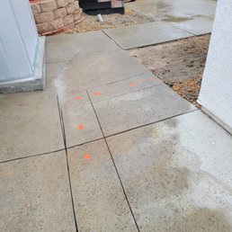 a concrete patio with orange markers