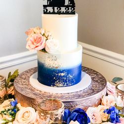 Adela & Co Bakery - Two tiered ombré wedding cake with florals and gold accents. Topper provided by bride