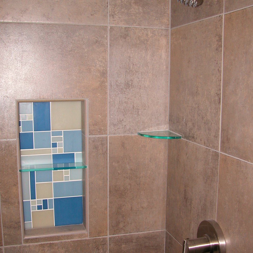 Winter Construction - a tiled shower with a window - General Contractors Near Me - Port Orchard, Washington