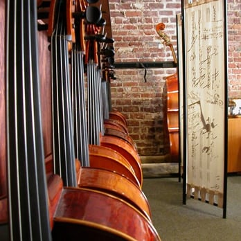 Tulsa Violin Shop - Looking down a row of cellos at Tulsa Violin Shop - Musical Instruments & Teachers Near Me - Tulsa, Oklahoma