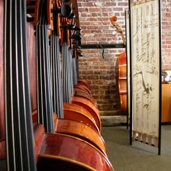 Tulsa Violin Shop - Looking down a row of cellos at Tulsa Violin Shop