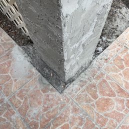a closeup of the base of a concrete column a closeup of the base of a concrete column