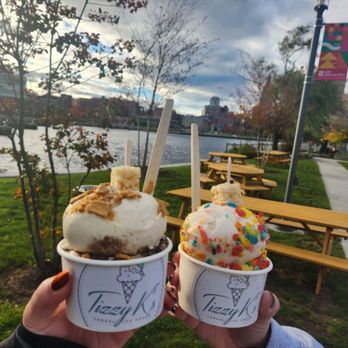 Tizzy K’s Cereal Ice Cream - Cinnamon Toast Crunch, Oreo, and Fruity Pebbles scoops with the riverside seating area in the background - Ice Cream & Frozen Yogurt Near Me - Providence, Rhode Island