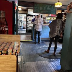 Countrypie Pizza - Menu is over the counter.  People are waiting to pick up take out orders.