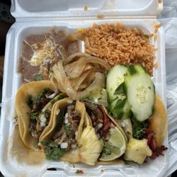 Carnitas and al pastor tacos with rice and beans.