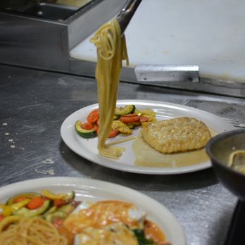 Capriccio Italian Restaurant - Fresh pasta being plated to perfection in the kitchen -- every dish is made with care just before it reaches your table. - Italian Near Me - Rogers, Arkansas Capriccio Italian Restaurant - Fresh pasta being plated to perfection in the kitchen -- every dish is made with care just before it reaches your table. - Italian Near Me - Rogers, Arkansas