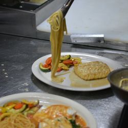Capriccio Italian Restaurant - Fresh pasta being plated to perfection in the kitchen -- every dish is made with care just before it reaches your table.