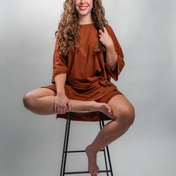 Nakita the Photographer - Modern personal branding portrait in studio with relaxed posing and editorial styling.