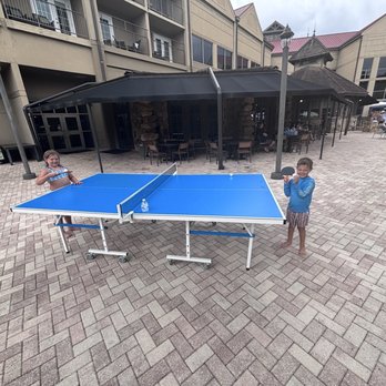 Legacy Lodge - Fun area around the pool. There is a giant chess game and they put out this ping pong table when it finally stopped raining - Venues & Event Spaces Near Me - Buford, Georgia