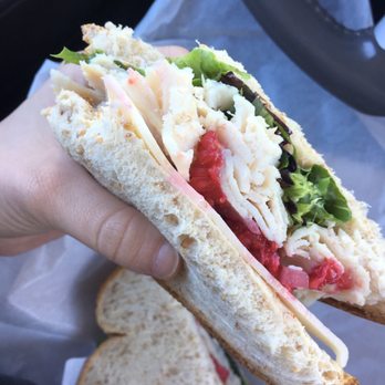 Uptown Downtown - a person holding a sandwich in their hand - Bakeries Near Me - Ruston, Louisiana Uptown Downtown - a person holding a sandwich in their hand - Bakeries Near Me - Ruston, Louisiana