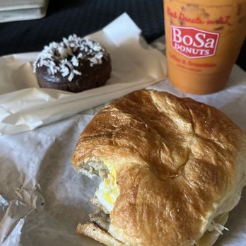 Bosa Donuts - Thai Iced Tea, Sausage, Egg, and Cheese Sandwich and devil food coconut donut. - Donuts Near Me - Chandler, Arizona