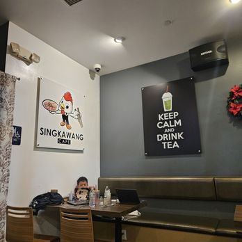 Singkawang Cafe - a woman sitting at a table - Indonesian Near Me - El Monte, California Singkawang Cafe - a woman sitting at a table - Indonesian Near Me - El Monte, California