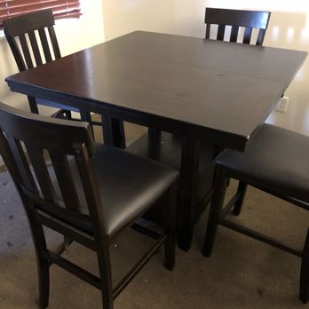 Ashley Store - Dining table set up with stains clearly surrounding where they were handling materials. - Furniture Stores Near Me - Bakersfield, California Ashley Store - Dining table set up with stains clearly surrounding where they were handling materials. - Furniture Stores Near Me - Bakersfield, California