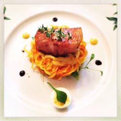 Restaurant Sonegg - Bacon-wrapped scallop on a bed of carrot spaghetti.