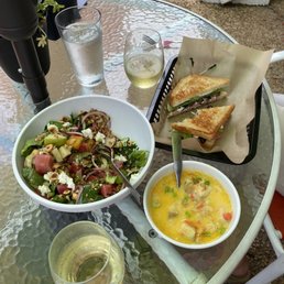 a bowl of soup and a sandwich on a table a bowl of soup and a sandwich on a table