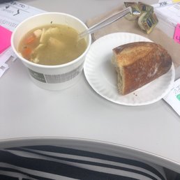 Cup of Chicken noodle soup and bread.