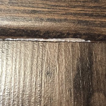 Costen Floors - Picture of chipping on threshold from constant kicking it back into place. - Flooring Near Me - Henrico, Virginia Costen Floors - Picture of chipping on threshold from constant kicking it back into place. - Flooring Near Me - Henrico, Virginia