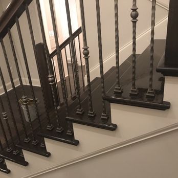 World's Best Flooring - a staircase with iron railings - Flooring Near Me World's Best Flooring - a staircase with iron railings - Flooring Near Me