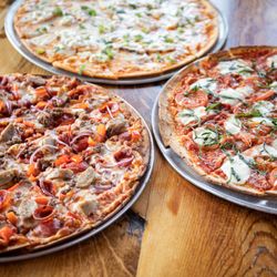 Clubhouse Bar & Grille - A few of the delicious new thin-crust pizzas on the menu: Chairman's Favorite, Margherita, and more!