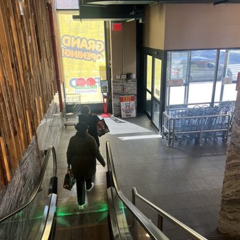 Food Bazaar Supermarket - a person on an escalator - Grocery Near Me - New York, New York Food Bazaar Supermarket - a person on an escalator - Grocery Near Me - New York, New York
